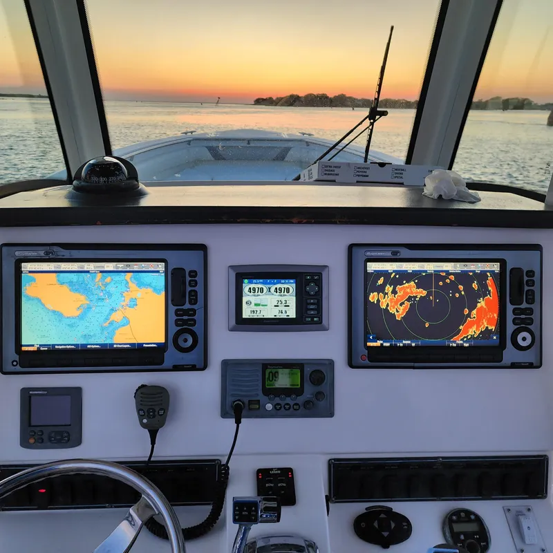 Slide: The Image of Boston Whaler 320 Outrage 2010 dashboard with navigation screens at sunset. - 7