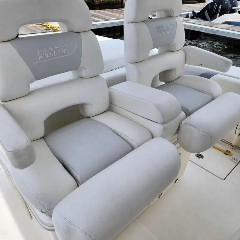 Slide: The Image of 2010 Boston Whaler 320 Outrage boat seats, white leather, docked. - 8