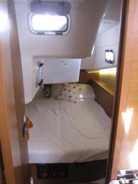 Slide: The Image of Cozy cabin interior of 2025 Jeanneau 380 sailboat with bed and porthole. - 16