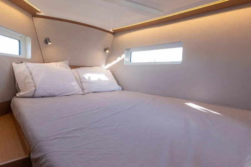 Slide: The Image of Cozy cabin interior of 2025 Jeanneau 380 yacht with natural light. - 2