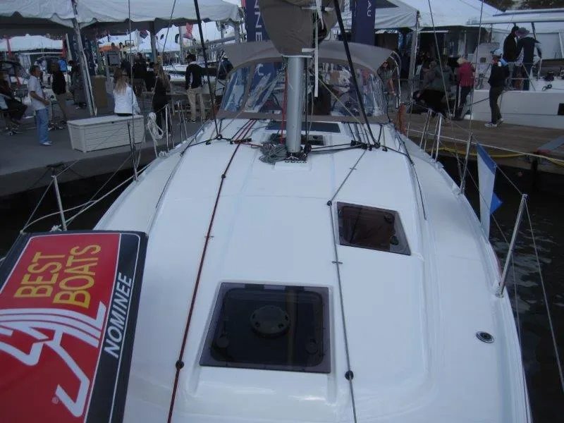 Slide: The Image of 2025 Jeanneau 380 sailboat at a boat show, featuring "Best Boats" nominee sign. - 27