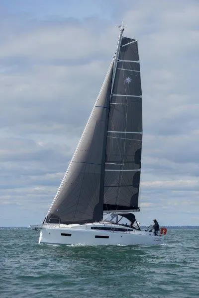 Slide: The Image of 2025 Jeanneau 380 sailboat cruising on open water under cloudy skies. - 34