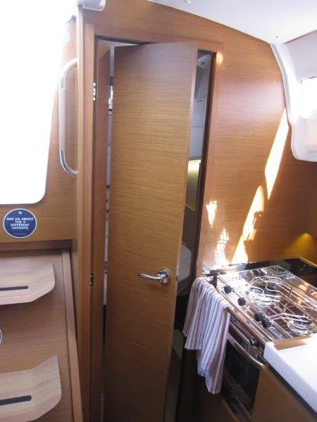 Slide: The Image of Interior of 2025 Jeanneau 380 sailboat with wooden cabinetry and modern kitchen. - 12
