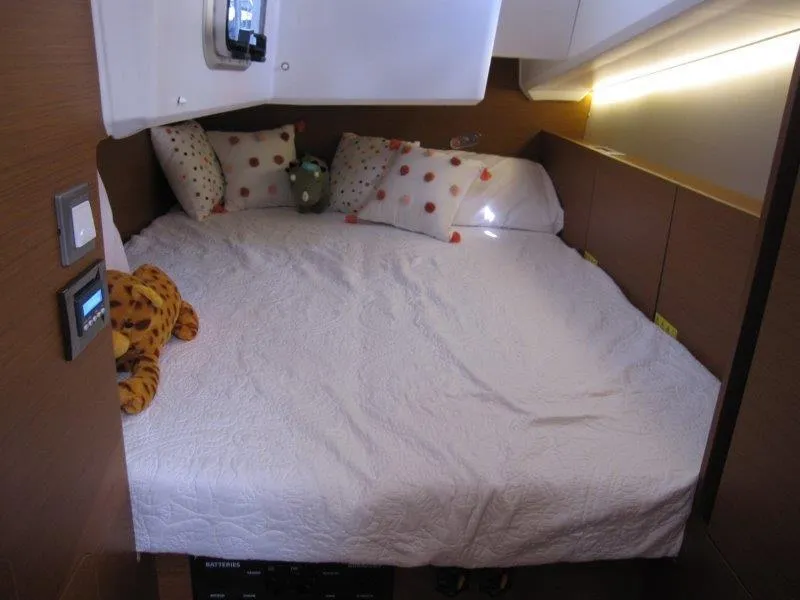 Slide: The Image of Cozy cabin bedroom in 2025 Jeanneau 380 yacht with plush bedding and soft lighting. - 14