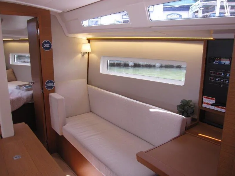 Slide: The Image of Interior of 2025 Jeanneau 380 yacht, featuring a cozy seating area and modern design. - 2