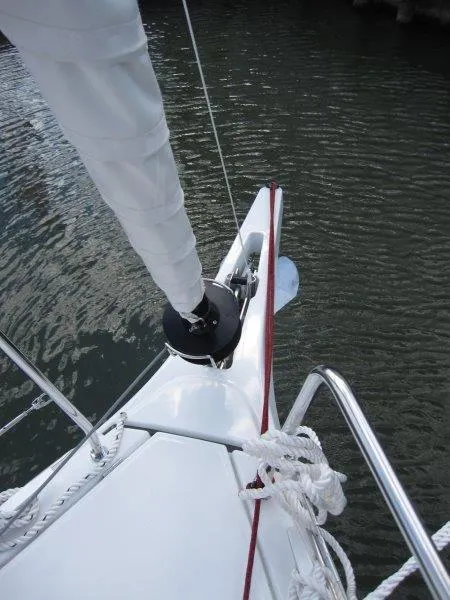 Slide: The Image of 2025 Jeanneau 380 sailboat bow with rigging on calm water. - 24