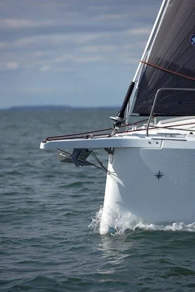 Slide: The Image of 2025 Jeanneau 380 sailboat cutting through water, showcasing sleek design. - 33