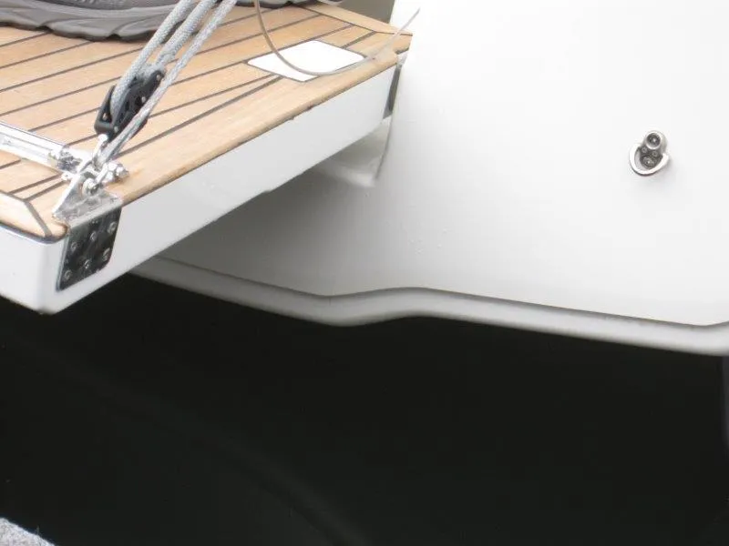 Slide: The Image of Jeanneau 380 sailboat stern detail, 2025 model, featuring teak deck and hardware. - 37