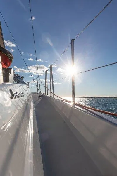 Slide: The Image of 2025 Jeanneau 380 sailboat deck with sunlit ocean view. - 39