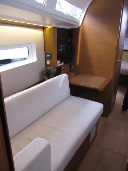 Slide: The Image of 2025 Jeanneau 380 yacht interior with modern seating and wooden finishes. - 6