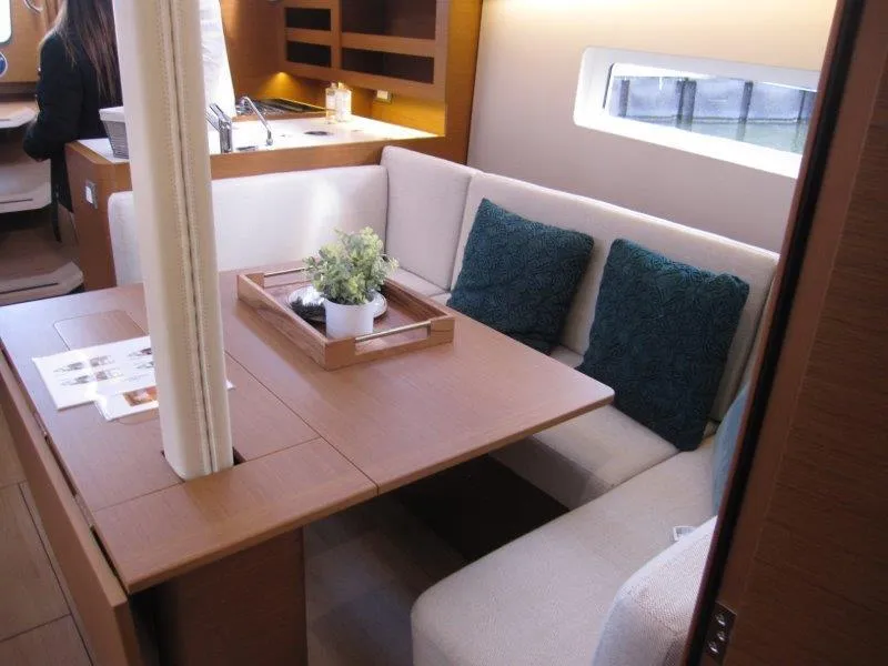 Slide: The Image of Modern interior of 2025 Jeanneau 380 yacht with cozy seating and dining area. - 7