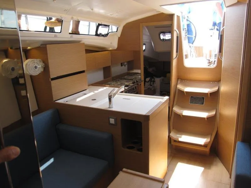 Slide: The Image of Interior of 2025 Jeanneau Sun Odyssey 350 sailboat with modern kitchen and seating area. - 29
