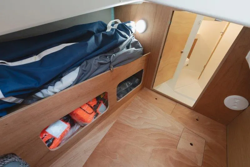 Slide: The Image of Interior cabin of 2025 Jeanneau Sun Odyssey 350 sailboat, featuring storage and cozy design. - 49