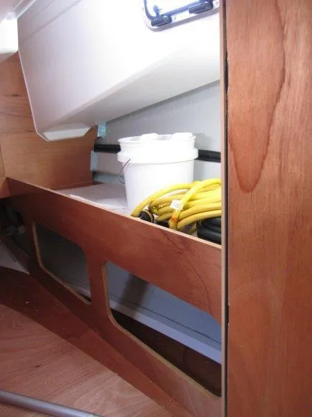 Slide: The Image of Interior storage of 2025 Jeanneau Sun Odyssey 350 sailboat with wooden finish. - 18