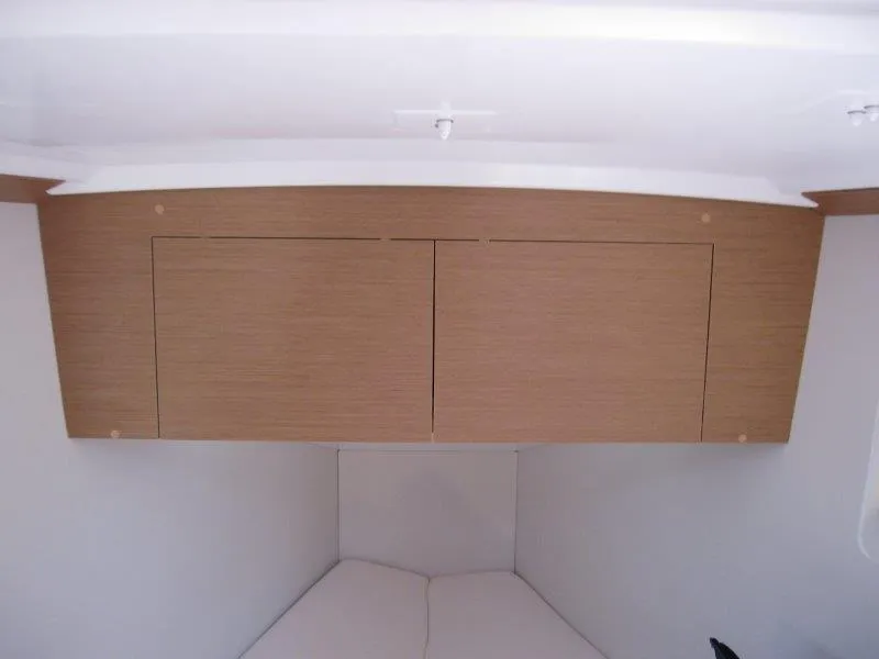 Slide: The Image of Interior cabin of 2025 Jeanneau Sun Odyssey 350 with wooden storage cabinets. - 32