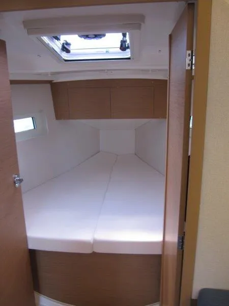 Slide: The Image of 2025 Jeanneau Sun Odyssey 350 cabin interior with skylight and cozy bedding. - 7