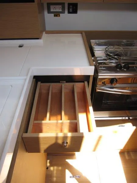 Slide: The Image of 2025 Jeanneau Sun Odyssey 350 yacht kitchen with open drawer and stove. - 41