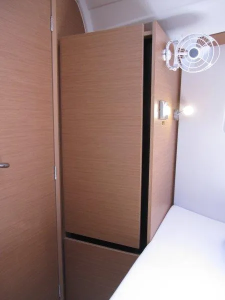 Slide: The Image of Interior of 2025 Jeanneau Sun Odyssey 350 yacht with wooden cabinetry and fan. - 25