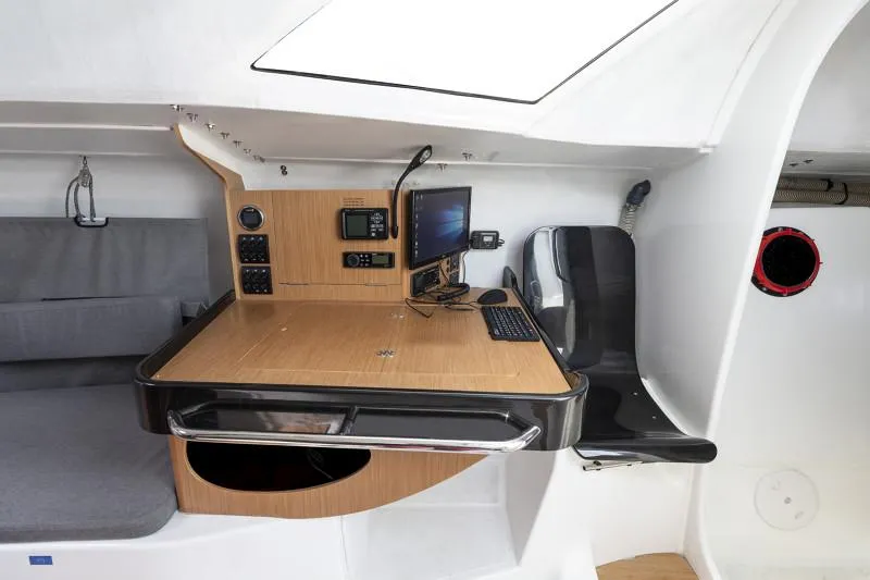 Slide: The Image of 2025 Jeanneau Sun Fast 3300 navigation station with modern equipment and seating. - 41