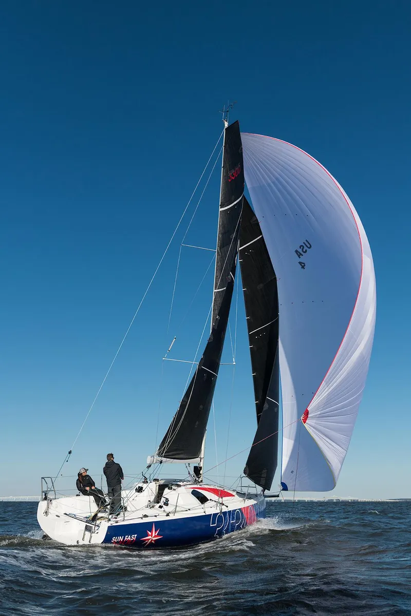 Slide: The Image of 2025 Jeanneau Sun Fast 3300 sailing on open water under clear blue sky. - 19