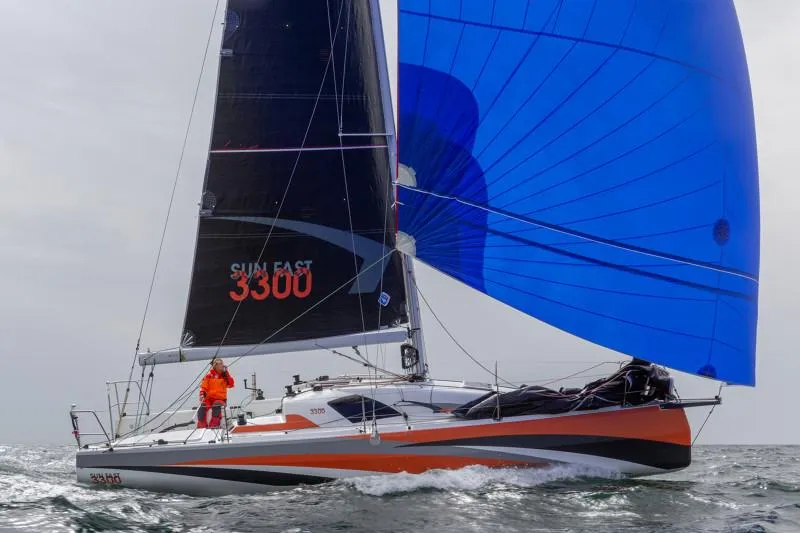 Slide: The Image of 2025 Jeanneau Sun Fast 3300 sailing with blue spinnaker on open water. - 28