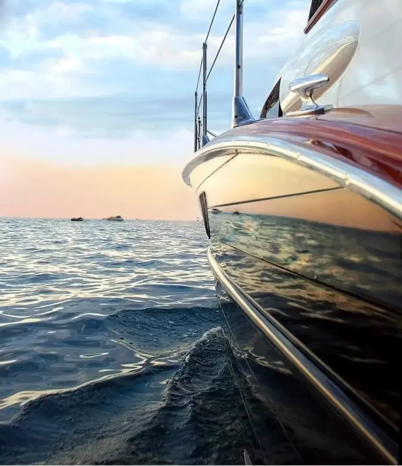 Slide: The Image of 1957 Chris-Craft 33 Futura boat on calm water at sunset. - 10