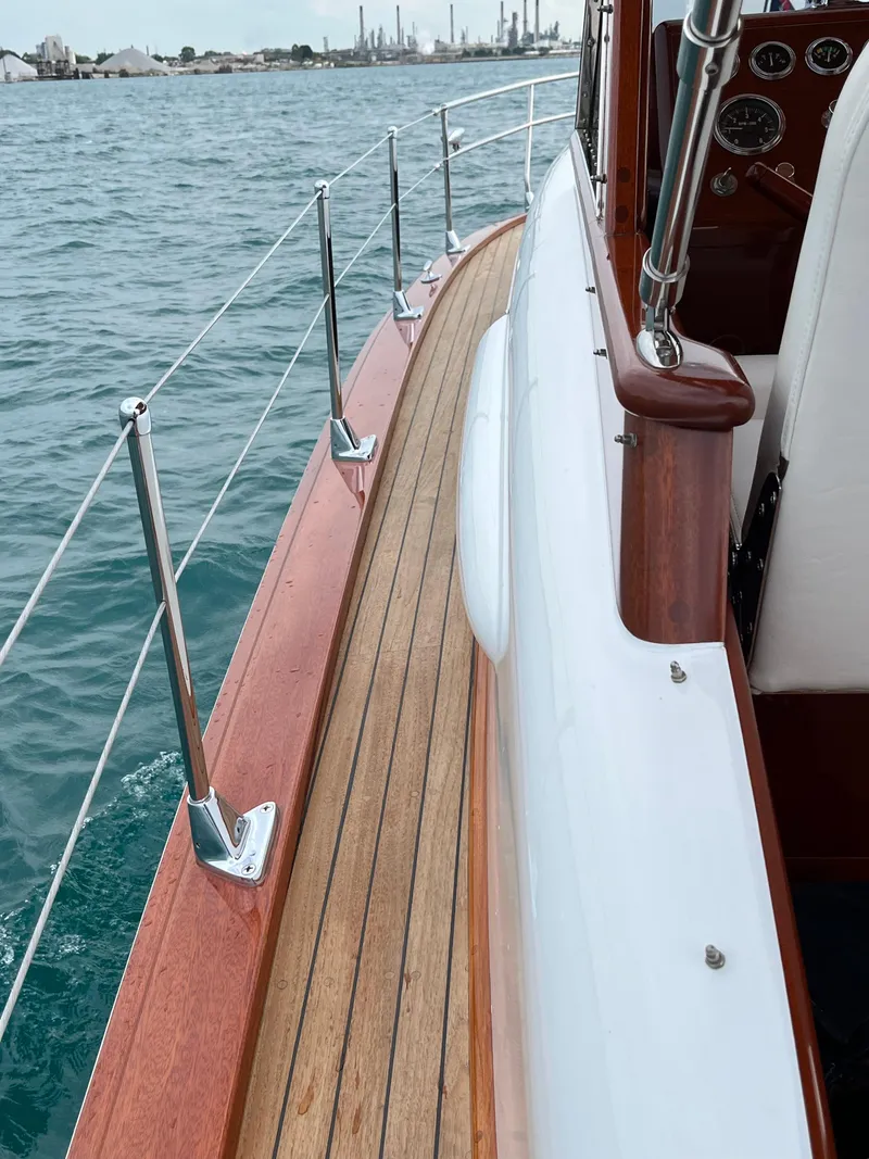Slide: The Image of 1957 Chris-Craft 33 Futura boat deck with wooden finish, cruising on water. - 12