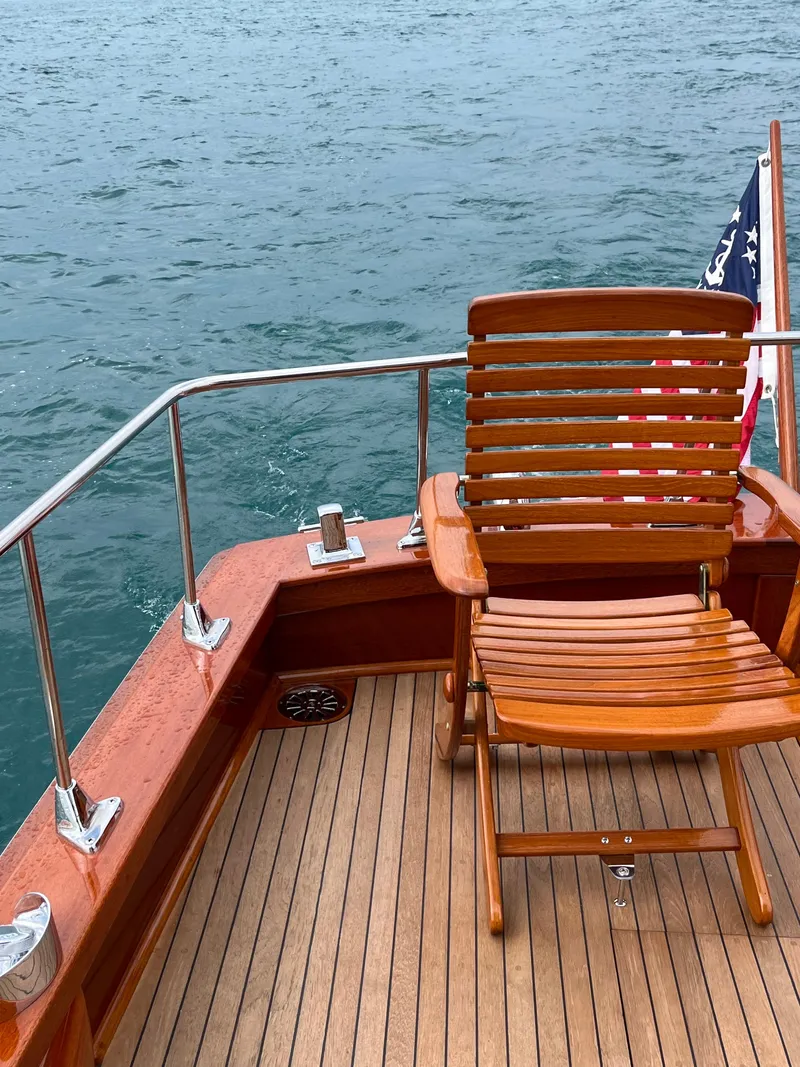 Slide: The Image of 1957 Chris-Craft 33 Futura boat deck with wooden chair and American flag. - 13