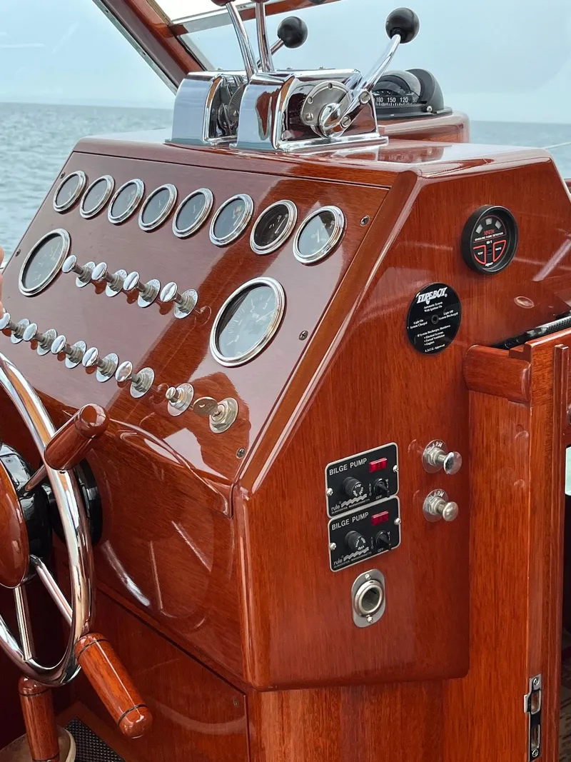 Slide: The Image of 1957 Chris-Craft 33 Futura boat dashboard with vintage wooden controls and gauges. - 15