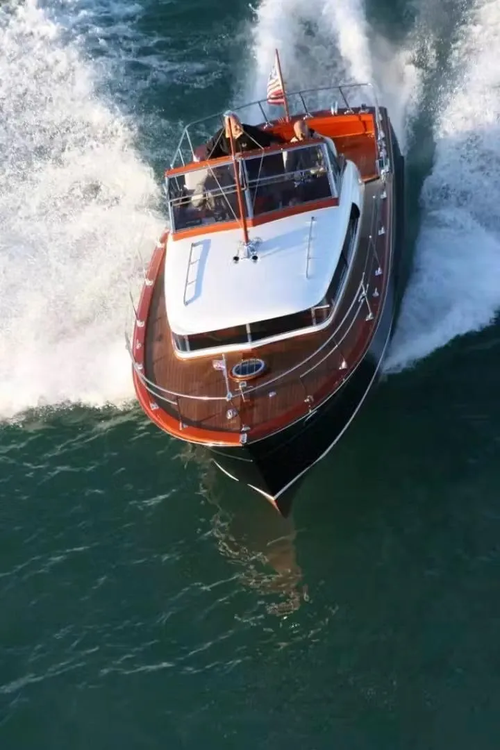 Slide: The Image of 1957 Chris-Craft 33 Futura cruising on open water, showcasing classic wooden design. - 20