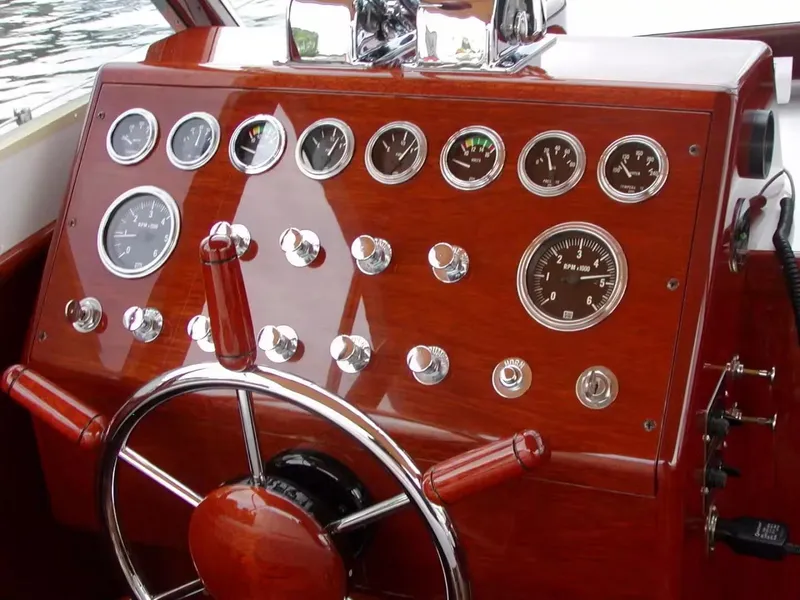 Slide: The Image of 1957 Chris-Craft 33 Futura dashboard with classic wooden finish and vintage gauges. - 21