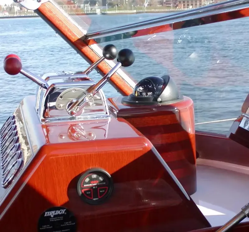Slide: The Image of 1957 Chris-Craft 33 Futura boat dashboard with controls and compass on water. - 22