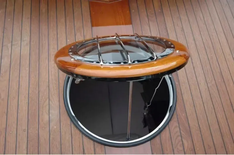 Slide: The Image of 1957 Chris-Craft 33 Futura boat hatch with wooden deck and open porthole. - 24