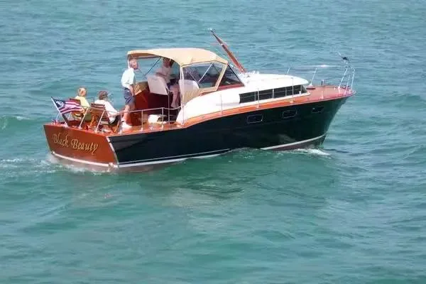 Slide: The Image of 1957 Chris-Craft 33 Futura boat cruising on open water with passengers onboard. - 5