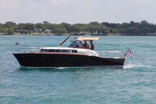 Slide: The Image of 1957 Chris-Craft 33 Futura cruising on a serene blue lake. - 8