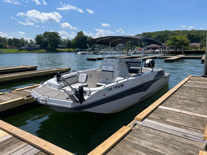 Slide: The Image of 2024 Starcraft SVX 211 OB CC boat docked on a sunny day. - 2