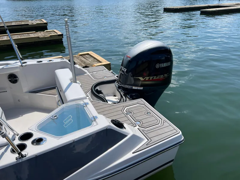 Slide: The Image of 2024 Starcraft SVX 211 OB CC boat with Yamaha VMAX engine on calm water. - 4