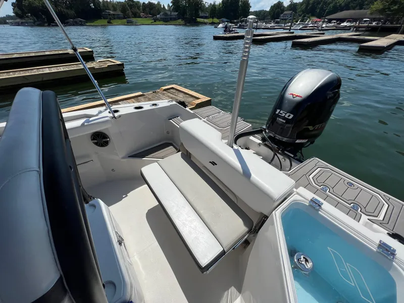 Slide: The Image of 2024 Starcraft SVX 211 OB CC boat with Yamaha 150 engine, docked on a sunny lake. - 7