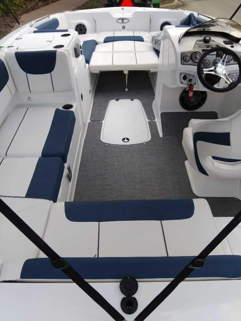 Slide: The Image of 2024 Tahoe 2150 boat interior with blue and white seating, modern dashboard, and spacious layout. - 3