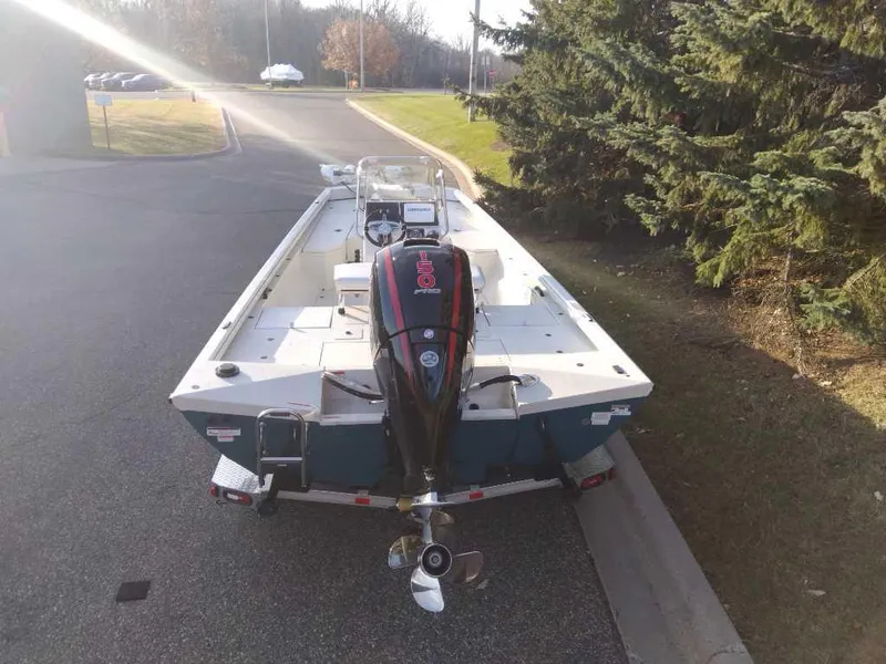 Slide: The Image of 2024 Ranger RB200 boat on trailer, parked near trees and road. - 3