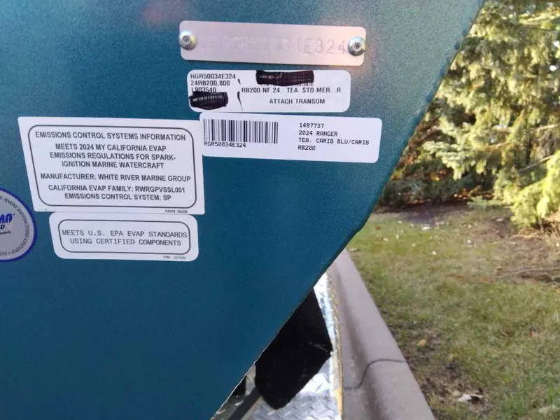 Slide: The Image of 2024 Ranger RB200 boat emissions labels and serial numbers on blue hull. - 5