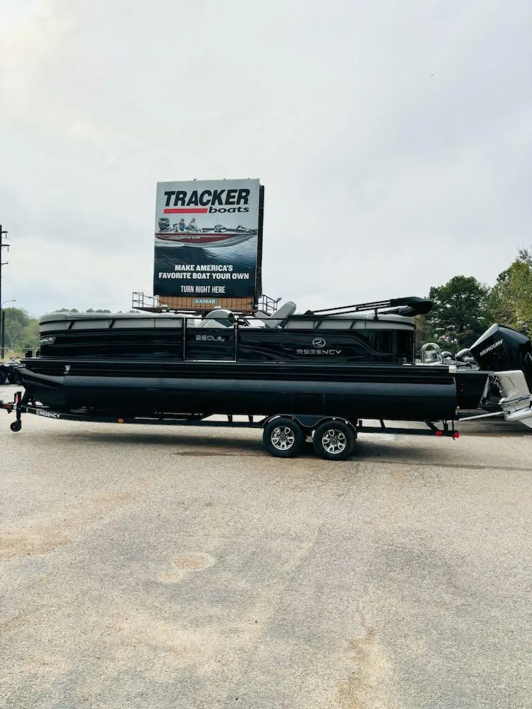 The Image of 2024 Regency 250 LE3 pontoon boat on trailer at dealership. - 0