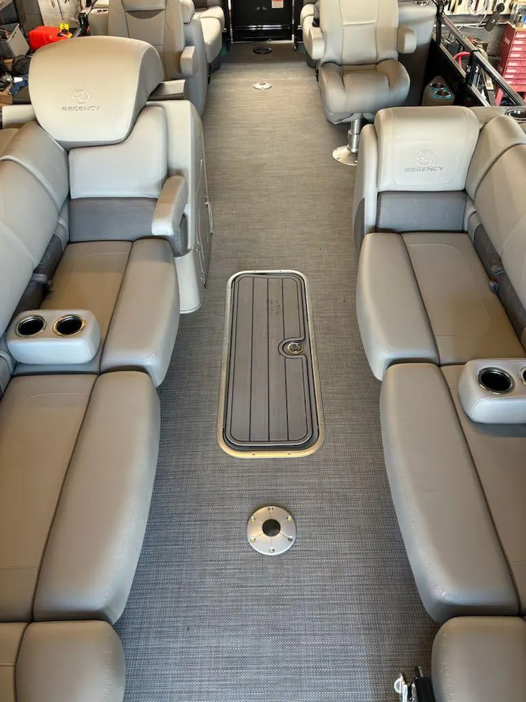 Slide: The Image of Luxurious interior of 2024 Regency 250 LE3 pontoon boat with plush seating and cup holders. - 5