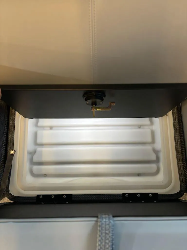 Slide: The Image of 2024 Regency 250 LE3 storage compartment with open lid, showcasing interior space. - 7