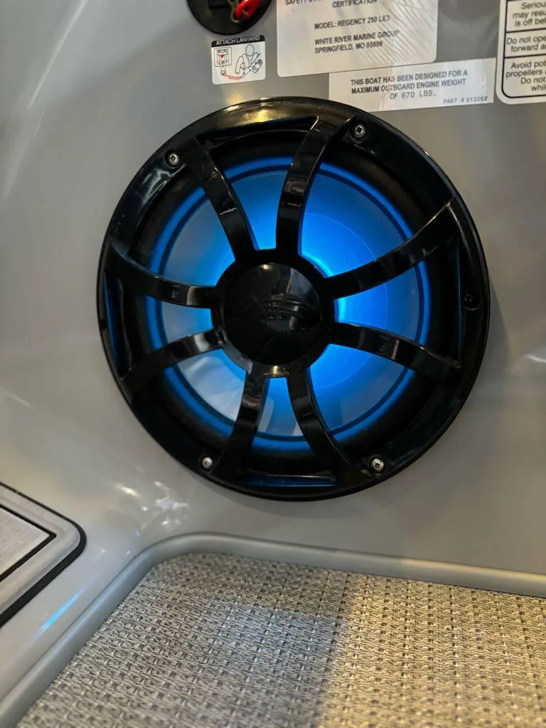 Slide: The Image of 2024 Regency 250 LE3 boat speaker with blue LED lighting. - 9