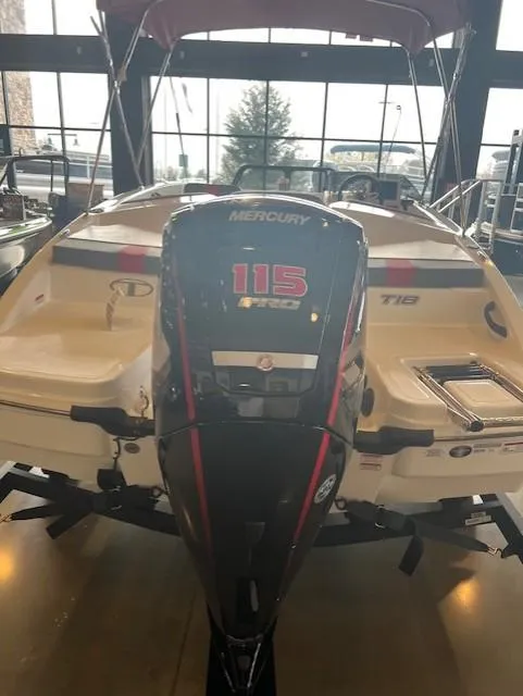 Slide: The Image of 2024 Tahoe T18 boat with Mercury 115 outboard motor in showroom. - 2