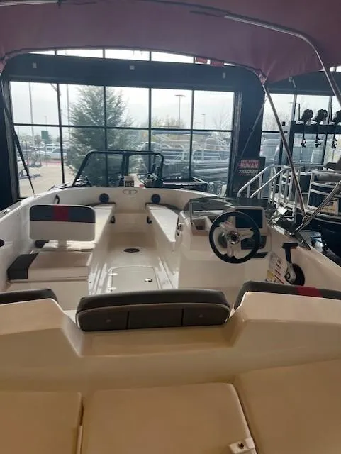 Slide: The Image of 2024 Tahoe T18 boat interior with seating and steering wheel in showroom. - 3