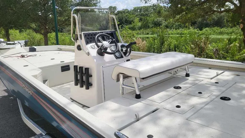 Slide: The Image of 2024 Ranger RB200 boat with console and seating, parked outdoors. - 4