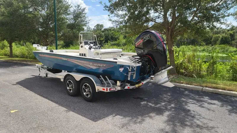 Slide: The Image of 2024 Ranger RB200 boat on trailer, parked outdoors near trees. - 5