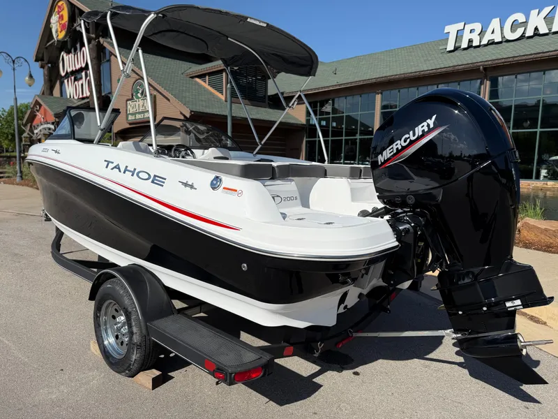 Slide: The Image of 2024 Tahoe 200 S boat with Mercury engine, parked outside a store. - 3